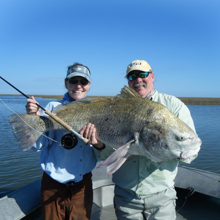 Couple holding big ugly fish